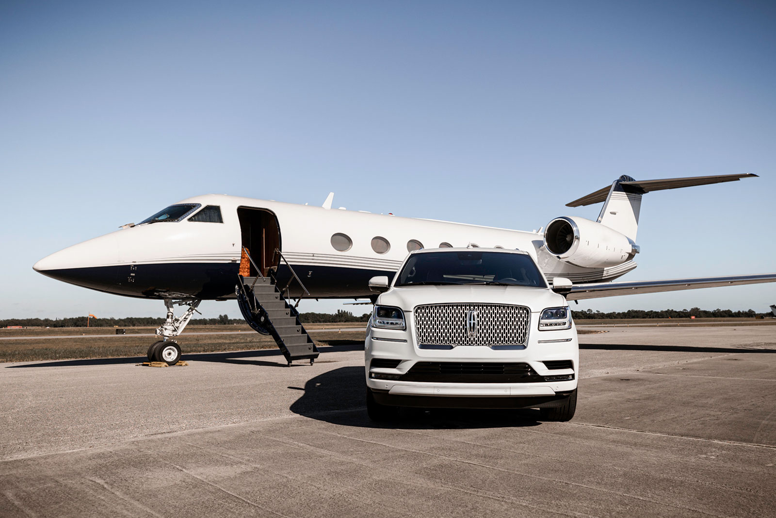 Aeraway jet on runway with Cadiallac Escalade